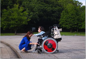 mom and child in wheelchair in park